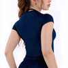 A woman wearing a navy blue performance fitness short sleeve top for women.