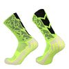 A pair of neon yellow and black anti-slip training socks shown from the side.