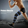 A muscular person wearing black compression leg sleeves while exercising outdoors.