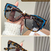 Blue Hawksbill sunglasses in black featuring a leopard print frame and clear lenses.