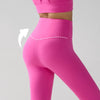Gros plan sur un legging de performance rose vif taille haute porté par un mannequin, mettant en valeur la coupe et la ceintu
