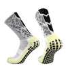 A pair of white and black patterned anti-slip training socks shown from the side.