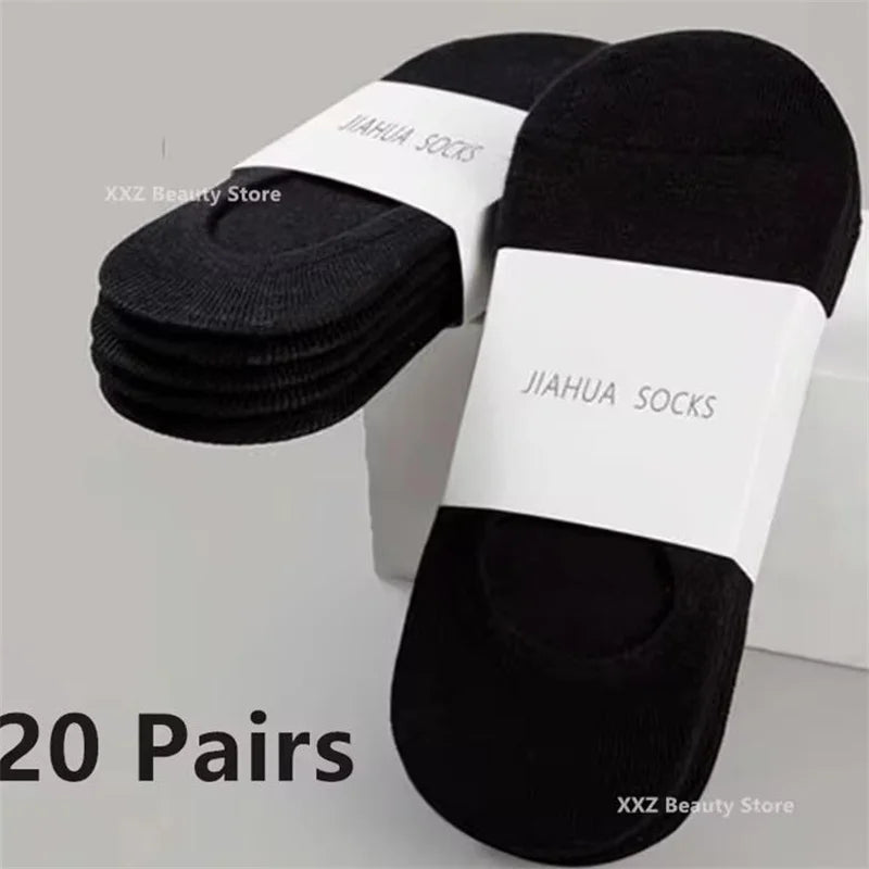 A pair of black invisible silicone no-show boat socks displayed on a white background.