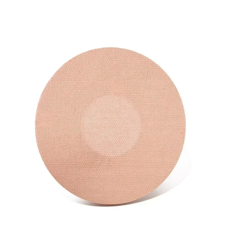 A round, light beige adhesive patch used for sensor fixing.