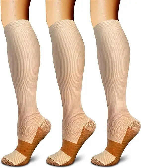 A set of three beige compression socks shown on a foot.