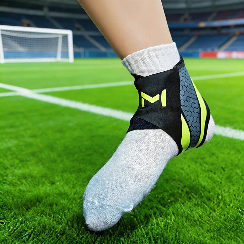 A close-up of a foot wearing a black and neon yellow knit ankle brace on a green soccer field.