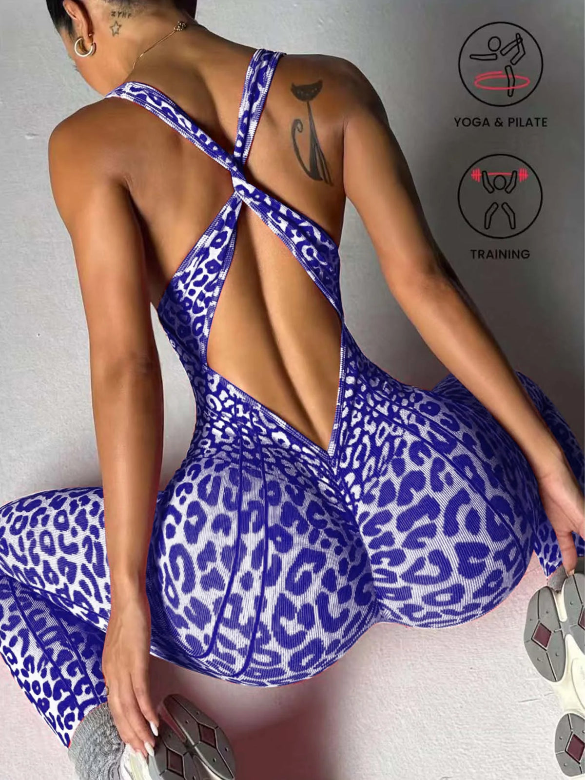A woman wearing a purple leopard print seamless yoga jumpsuit, viewed from the back.