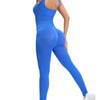 A woman wearing a bright blue ribbed nylon bodycon jumpsuit with a deep V back and long sleeves.