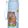 A light blue water bottle featuring a cute capybara design with glasses and holding a green drink.