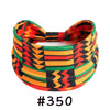 A colorful, patterned boho knotted cotton headband featuring geometric designs in orange, red, green, and black.