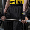 A muscular man wearing a yellow and black fitness lifting belt while exercising.