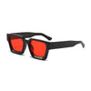 A pair of black retro square frame sunglasses with bright red lenses.