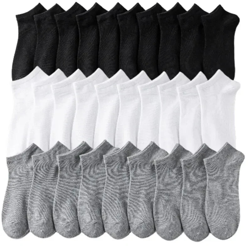 Stapel atmungsaktiver Polyester-Baumwoll-Strumpfhosen für Herren in Schwarz und Weiß.