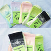 A collection of pastel colored and black pure cotton winter socks displayed on a light blue background.