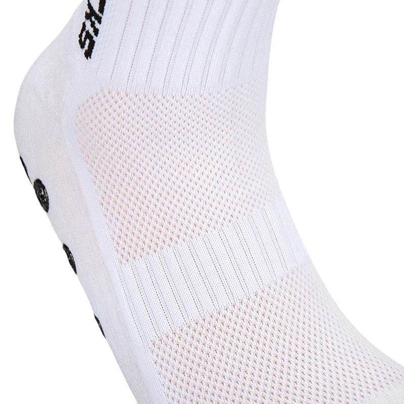 Close-up of white athletic soccer socks with a textured grip pattern on the foot area.