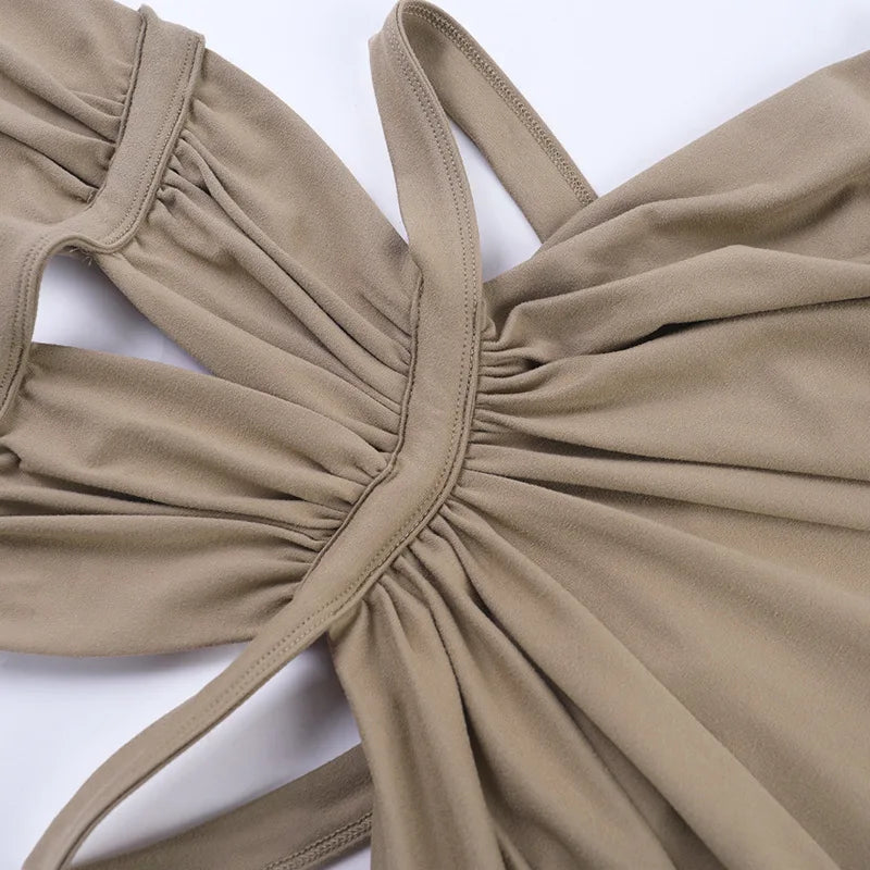 A close-up of a beige maxi dress with a draped cut-out back detail.