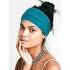 A woman wearing a teal stretch sport headband tied around her hair, looking directly at the camera.