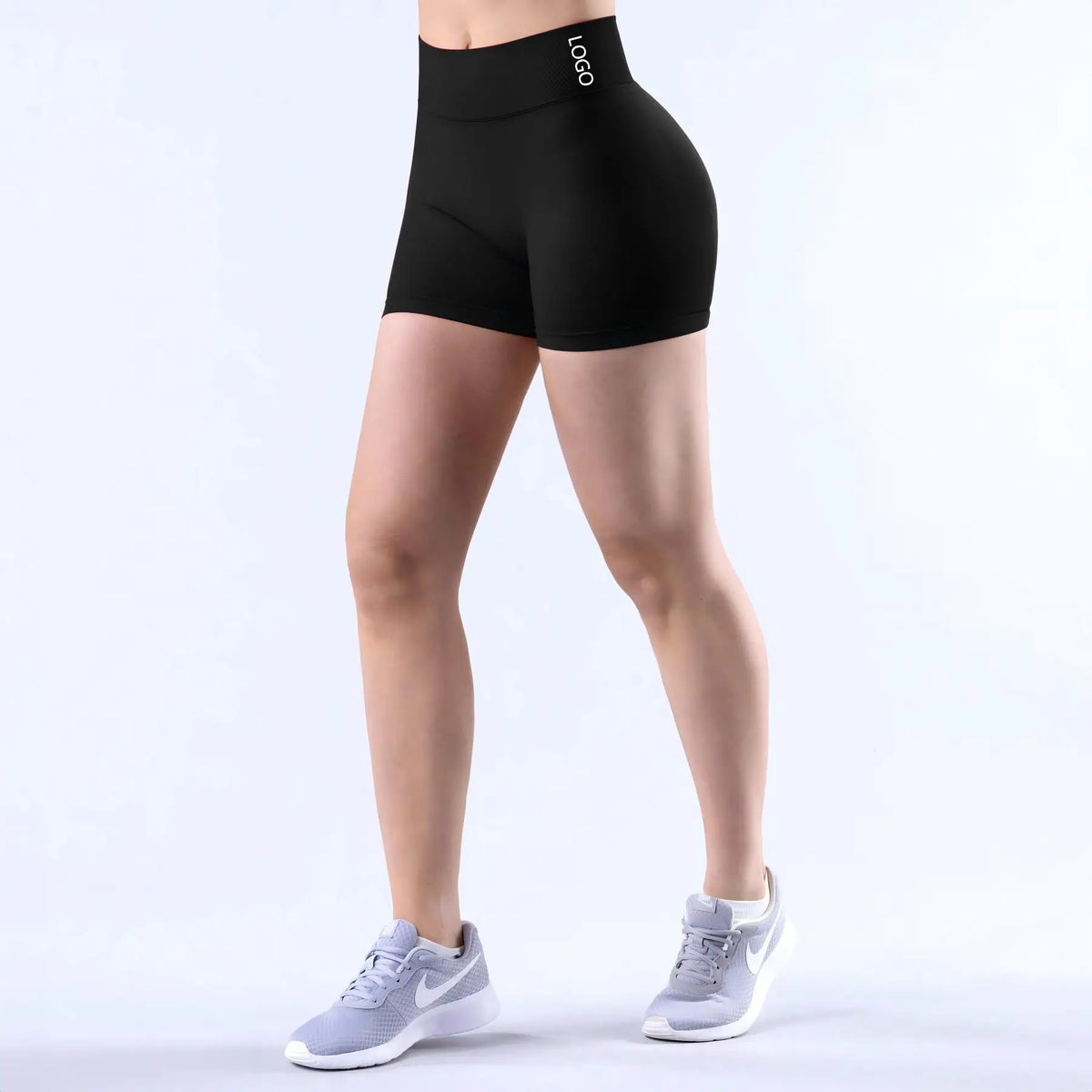 Black seamless high-waisted yoga shorts worn by a model, shown from the side.
