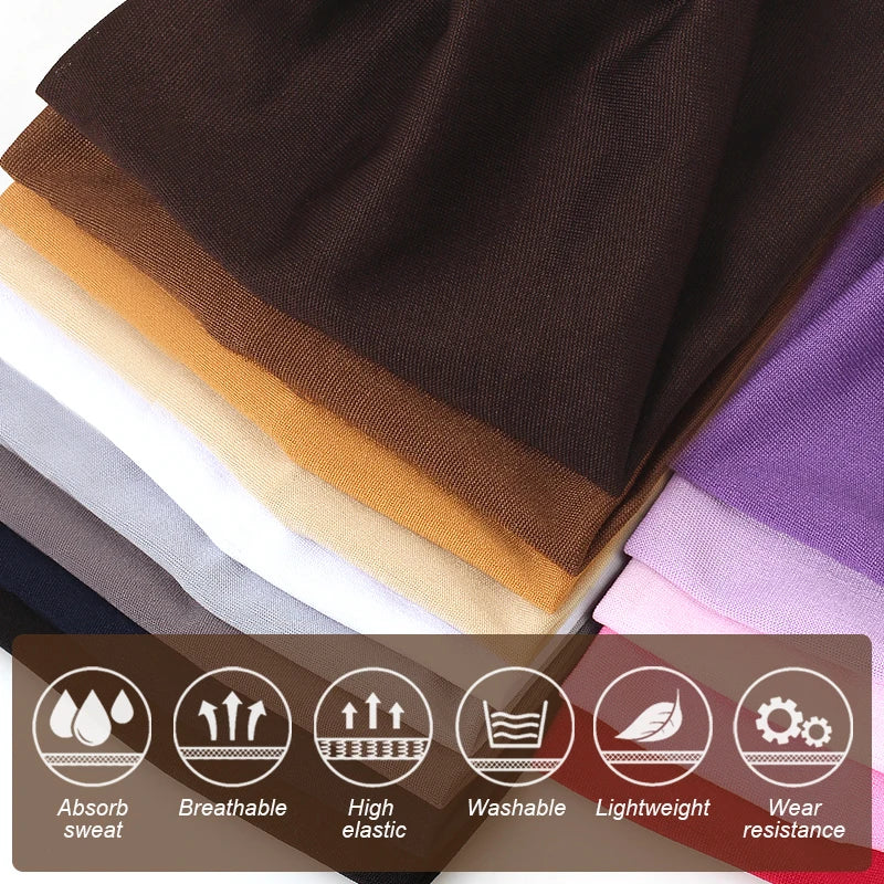 A stack of brown, beige, white, gray, and purple elastic headbands for yoga and sports.