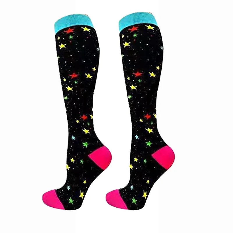 A pair of black compression elastic socks with blue and pink accents and yellow stars.