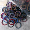 A pile of 50 pieces of mixed color elastic hair bands in various shades of purple, blue, and brown.