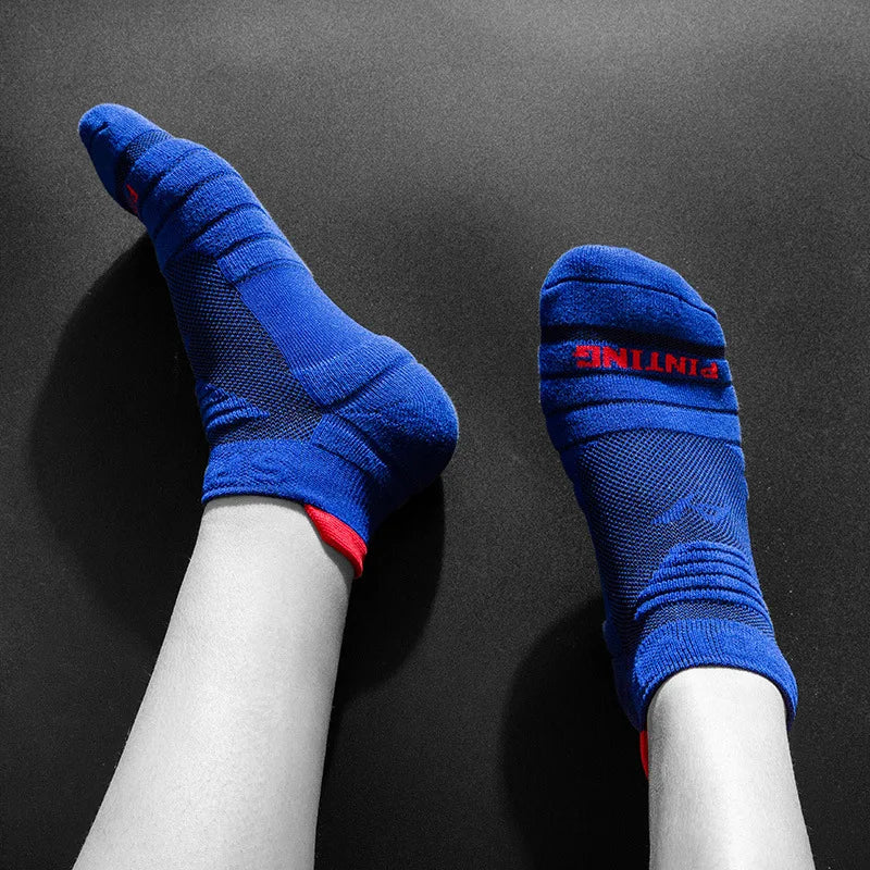 A pair of blue athletic ankle socks with red accents displayed on a person's lower leg.