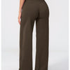 A woman wearing dark brown high-waist flared yoga pants standing in a full-length shot.