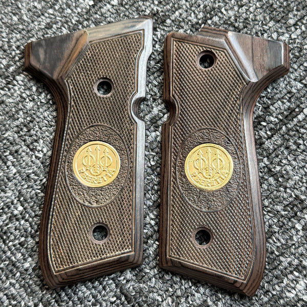 A pair of custom diamond pattern grips made of dark wood and textured material for a firearm.