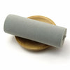 Gray elastic band rolled up on a wooden disk for sewing and decoration
