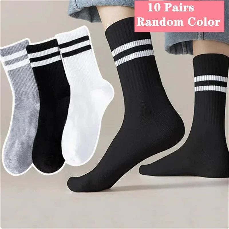 Ten pairs of random color striped casual socks displayed on a person's leg.