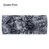 Diadema de tela elástica con estampado de serpiente en blanco y negro.