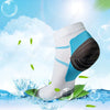 White and blue compression socks shown against a bright blue background with water splashes and green leaves.