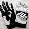 A pair of black and white durable motorcycle off-road riding gloves displayed on a white background.