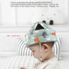 A baby is wearing a soft adjustable safety helmet designed for baby head protection.