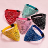 A collection of colorful, patterned adjustable pet scarves for dogs and kittens displayed on a light pink background.