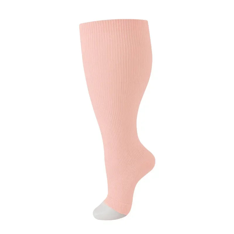 A full-length image of a light pink compression sock worn on a foot and ankle.
