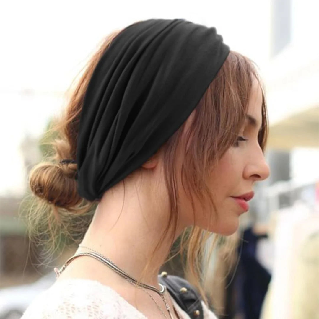 A woman wearing a black adjustable sports headband on her hair, shown in profile.