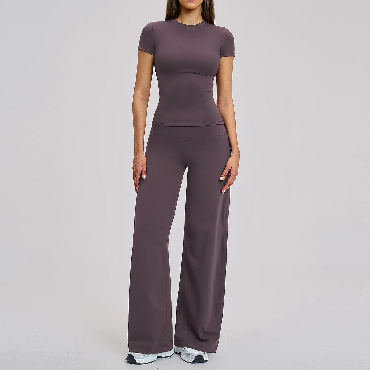 A woman wearing a mauve high-waist yoga and gym leggings set.