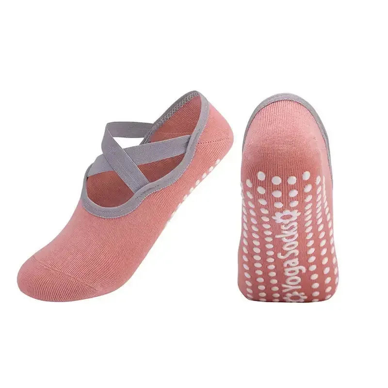 A pair of pink silicone anti-slip Pilates and yoga socks, showing the top and sole views.