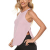 A woman wearing a light pink quick-dry yoga and gym tank top and black leggings.
