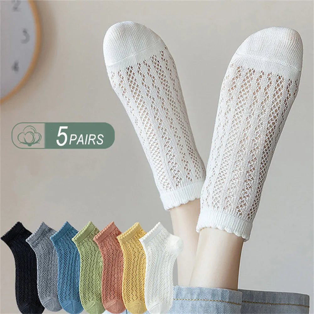 Five pairs of breathable mesh lace tube socks in various pastel colors displayed on a person's legs.