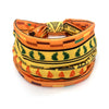 A colorful bohemian stretch cotton headband featuring geometric patterns in orange, yellow, and green.