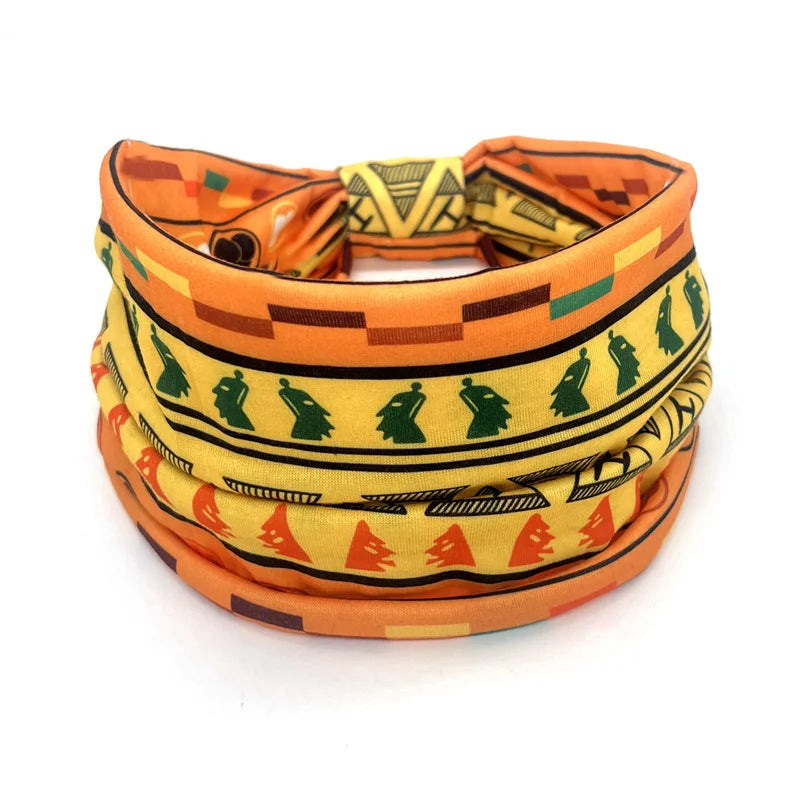 A colorful bohemian stretch cotton headband featuring geometric patterns in orange, yellow, and green.