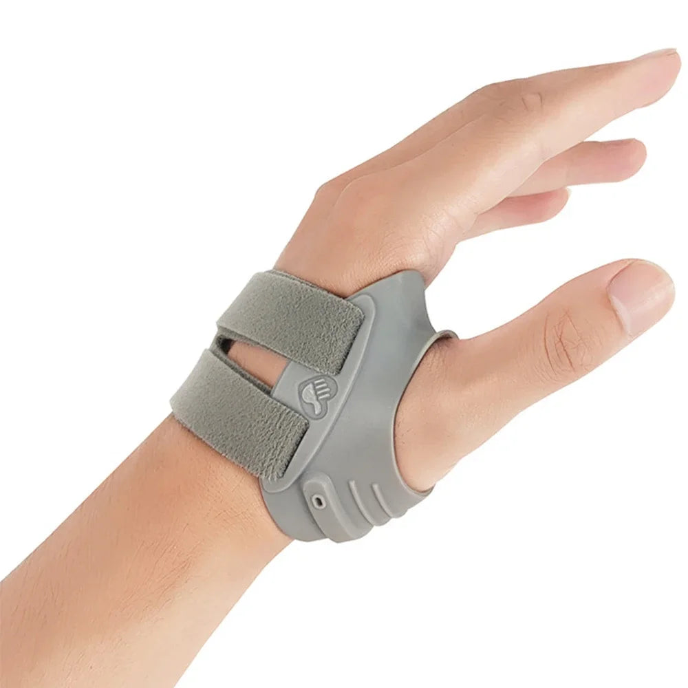 A hand wearing a gray thumb joint stabilizer brace for arthritis pain relief.