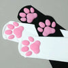 Black thigh high socks with pink cat paw print patterns.