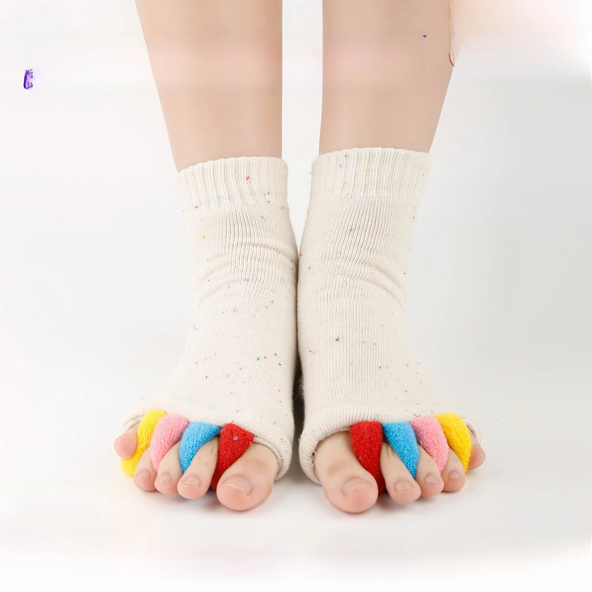 A pair of colorful five-finger yoga socks worn on a person's feet.