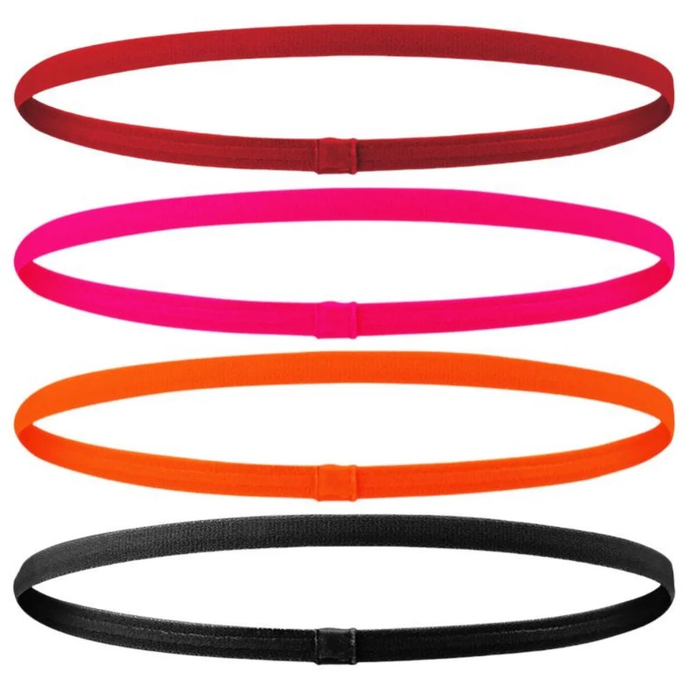 Vier elastische Sport-Headbänder in rot, pink, orange und schwarz.