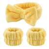 A set of yellow microfiber spa headband and wristband featuring a bow design.