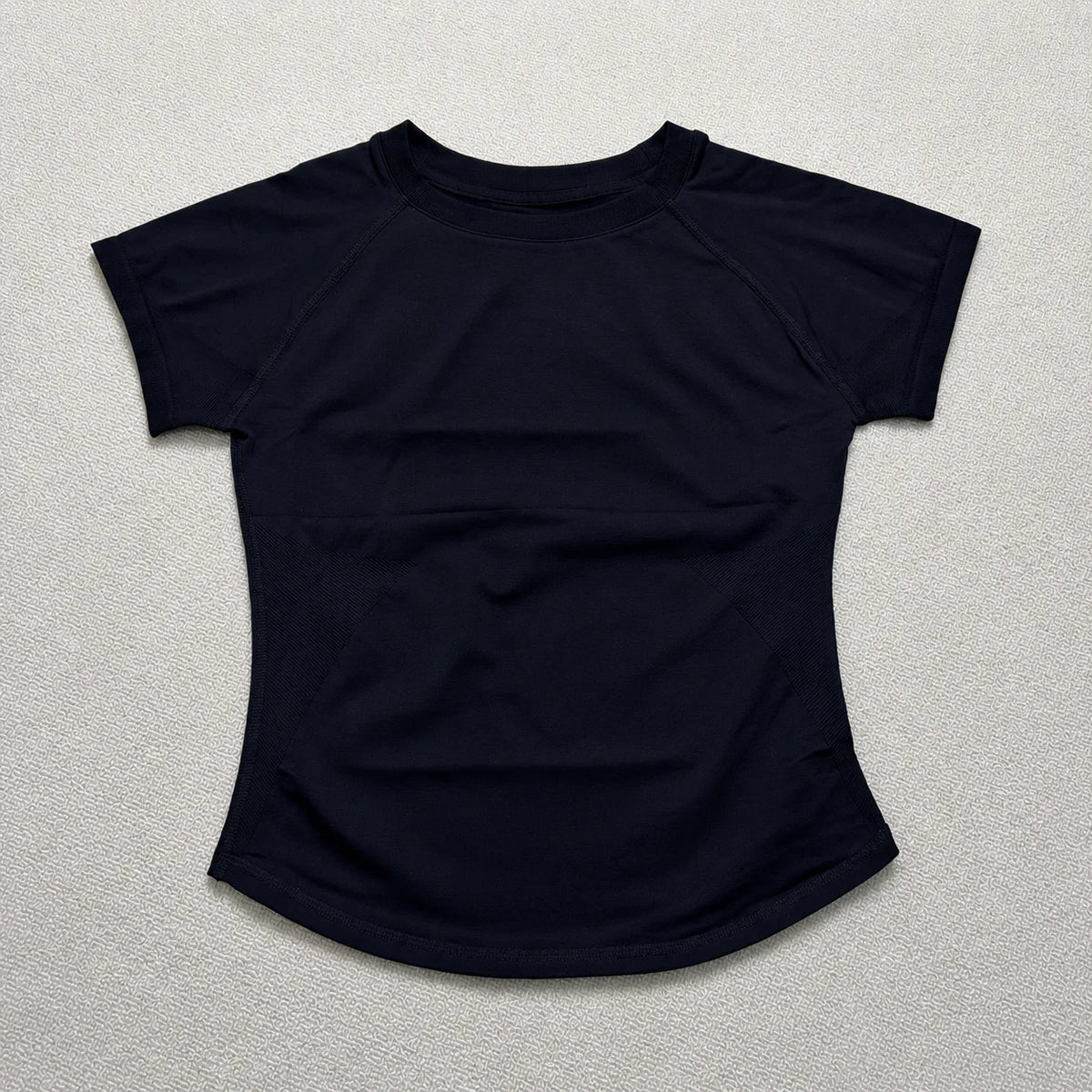 A navy blue seamless high-waist yoga set for women shown flat lay.