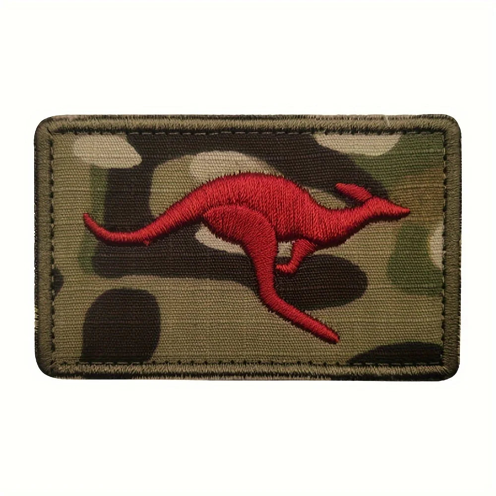 An embroidered patch featuring a red kangaroo silhouette on a camouflage fabric background.